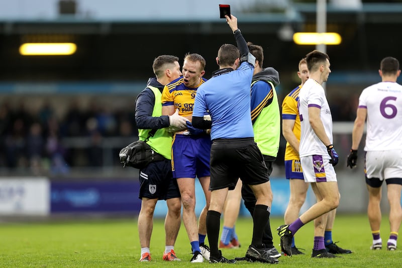 Paddy Quinn of Na Fianna receives a black card from referee Barry Tiernan during the Dublin senior county final at Parnell Park. Photograph: Laszlo Geczo/Inpho
