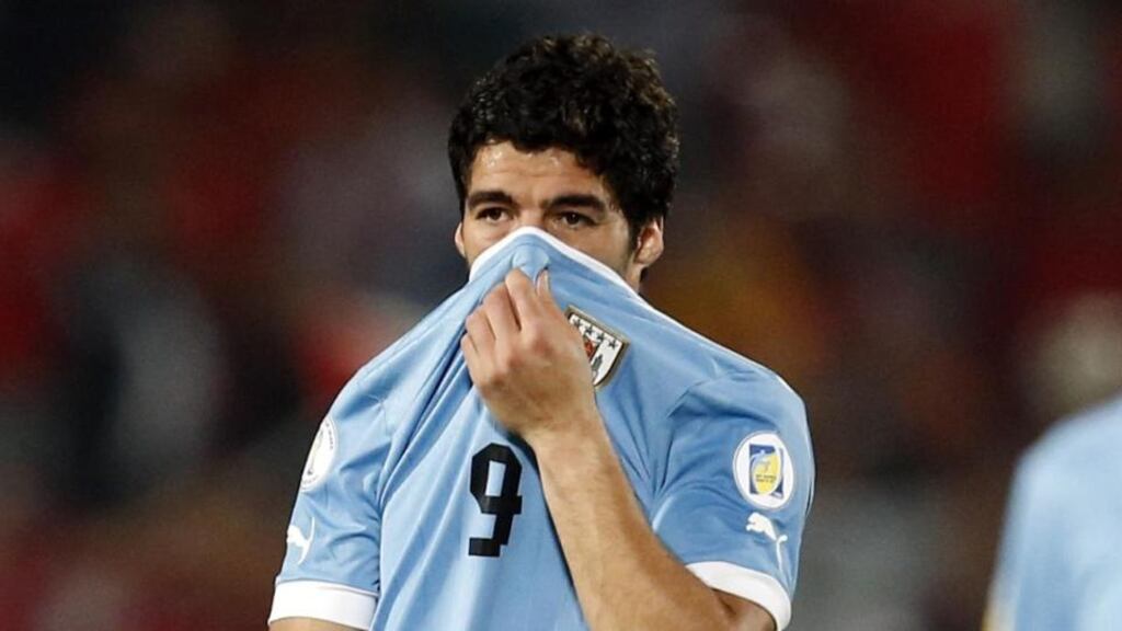 Uruguay's Luis Suarez, left, at the end of the 2-0 loss to Chile