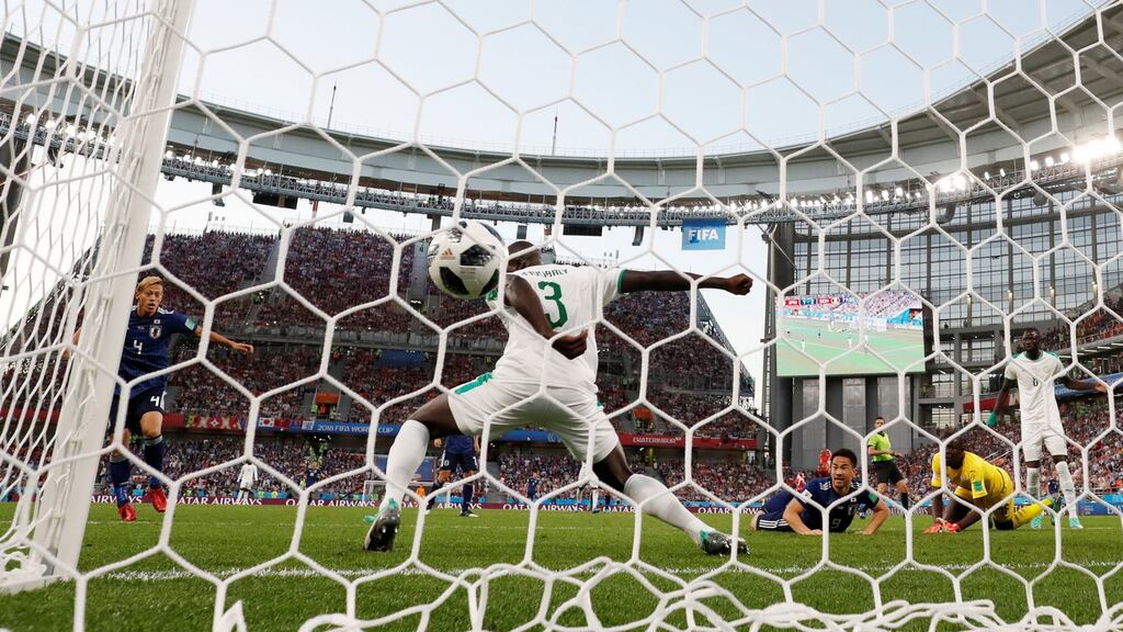 Keisuke Honda scores Japan’s second goal against Senegal. Photograph: Andrew Coulridge/Reuters