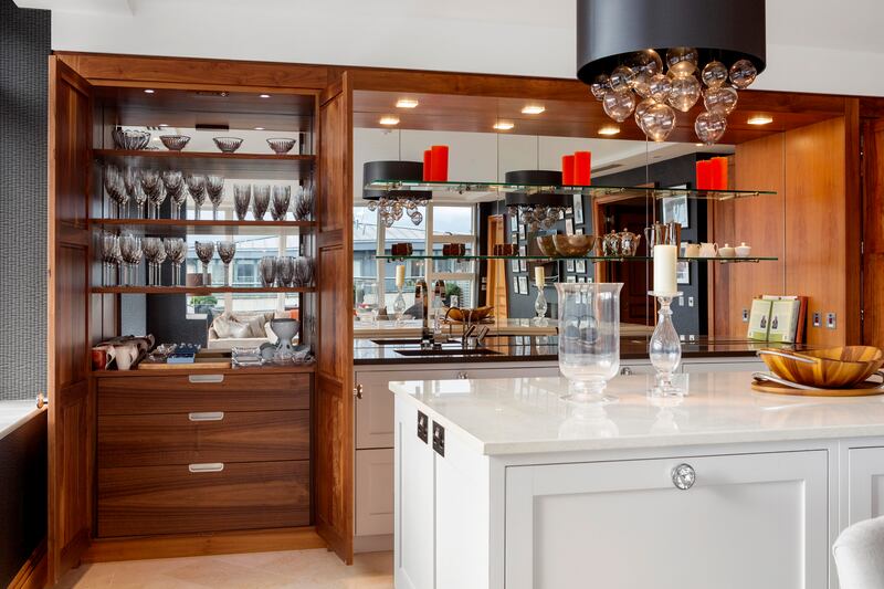 Two walnut pantries flank each side of the kitchen