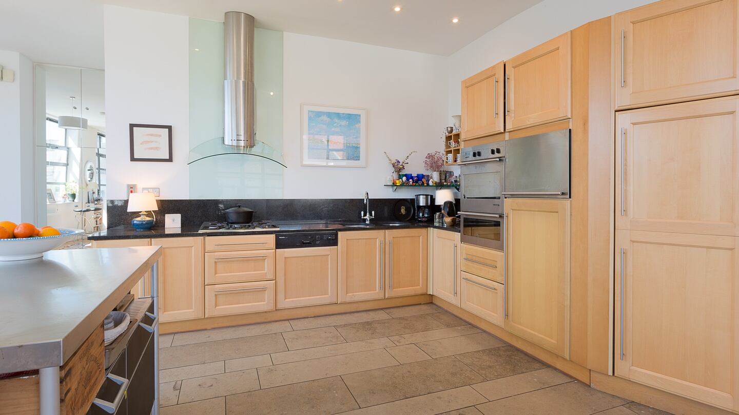 The kitchen, set in an L-shape, is to the left of the main living area