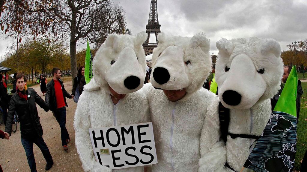 Three environmentalists wear polar bear costumes as they take part in a demonstration near the Eiffel Tower in Paris, France, as the World Climate Change Conference 2015 (COP21) on Saturday.  Photograph: Reuters