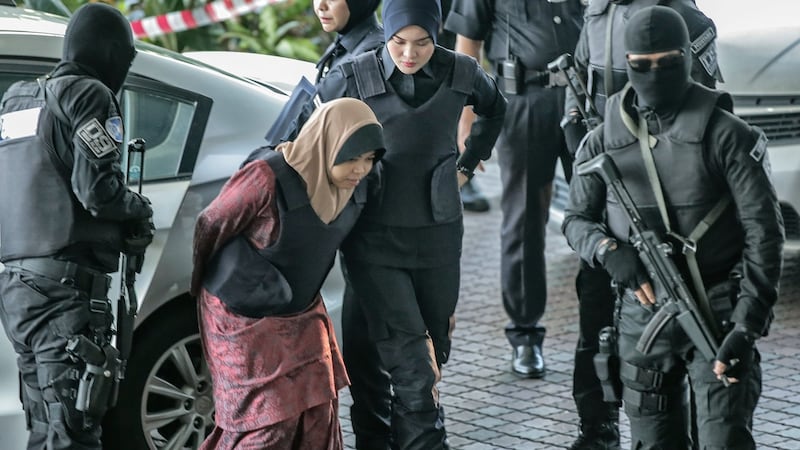 Siti Aisyah of Indonesia, who is being detained in connection with the death of Kim Jong-Nam, is escorted by Malaysian police officers as she arrives at the Shah Alam High Court, in Shah Alam, Malaysia, 27 February 2018. Photograph: EPA/AHMAD YUSNI