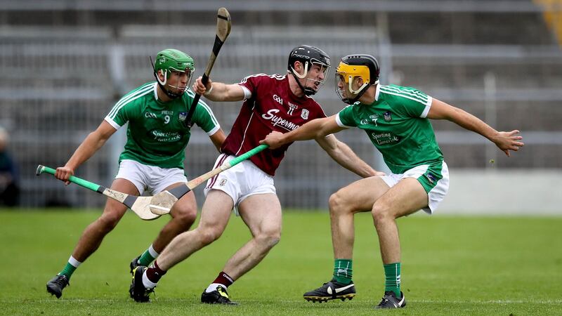 Galway’s Sean Linnane with Robbie Haley and Thomas Grimes of Limerick. Photograph: Ryan Byrne/Inpho