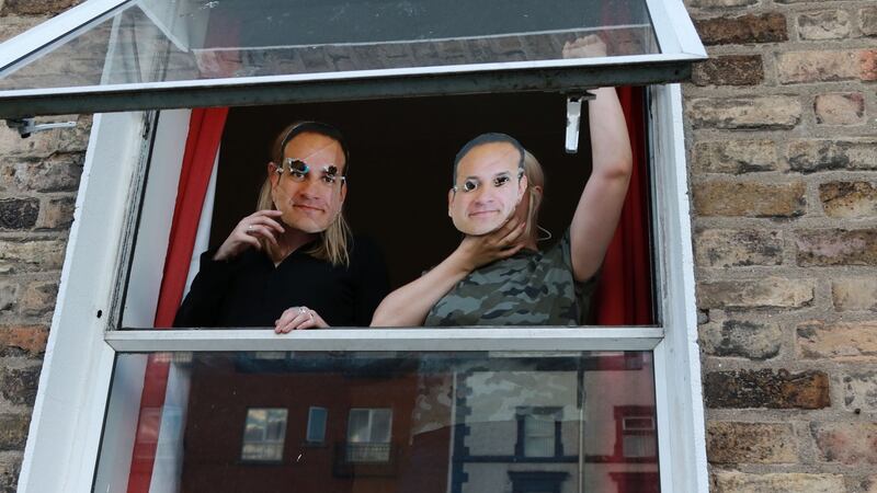Two individuals in the home wearing Leo Varadkar face masks hung a banner with the words “Homes for All” from the second floor window of the house. Photograph: Nick Bradshaw/Irish Times