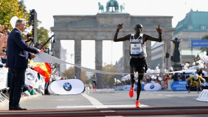 Dennis Kimetto of Kenya crosses the finish line in new world record time to win the 41st BMW Berlin Marathon. Photograph: Boris Streubel/Bongarts/Getty Images
