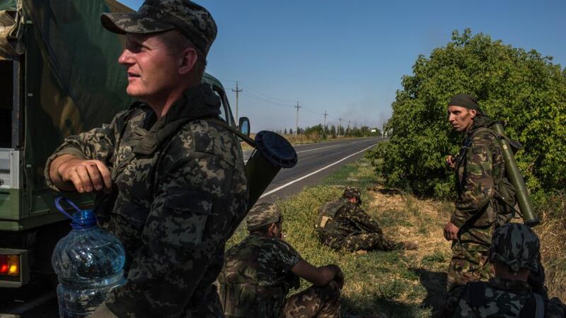 Ukrainian soldiers regroup in a defensive position after coming under heavy shelling in Novoazovsk, Ukraine, a town near the Russian border. Photograph: New York Times