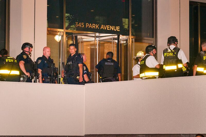 Police officers and firefighters outside the scene of the shooting. Photograph: Dakota Santiago/New York Times