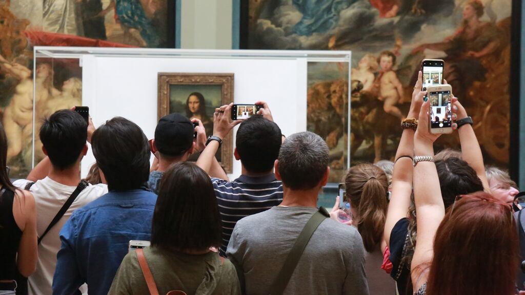 Visitors take photos of the Mona Lisa in the Medici Gallery at the Louvre in Paris: Museums are magnificent but do not let them cage culture. Photograph: Owen Franken/New York Times