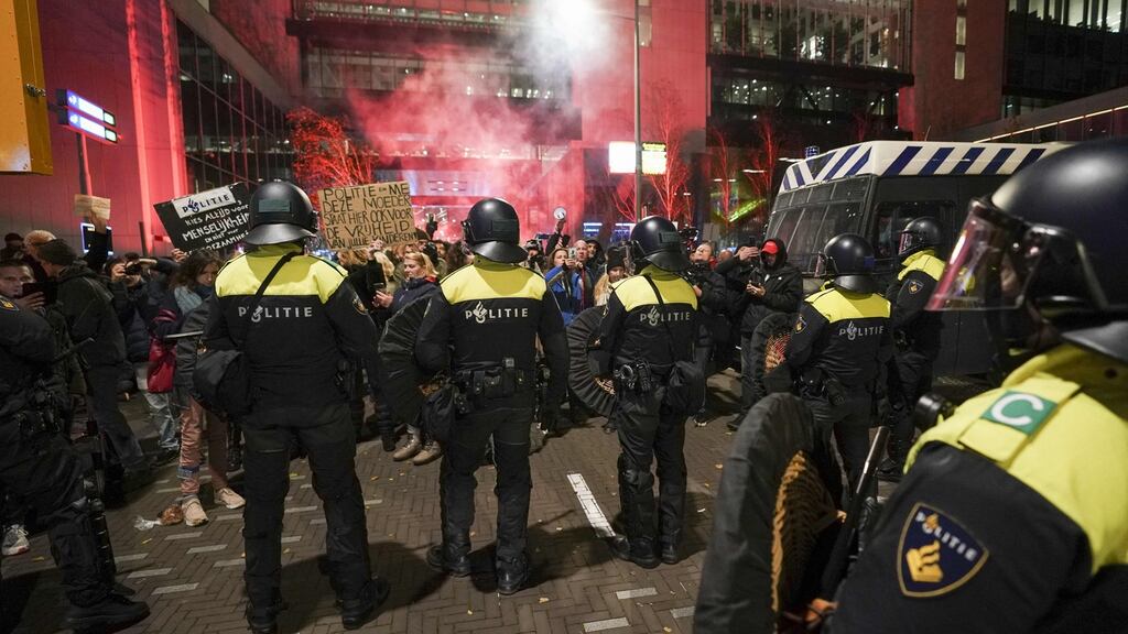 Riot police officers face protesters as they gather in the Hague. Photograph: Jeroen Jumelet / ANP / AFP via Getty
