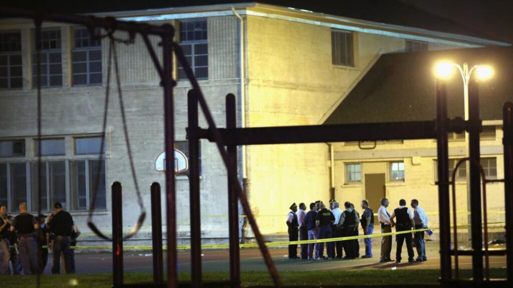 Police investigate the scene in Cornell Square Park on the south side of Chicago where 13 people including a three-year-old boy have been shot. Photograph: Scott Olson/Getty Images