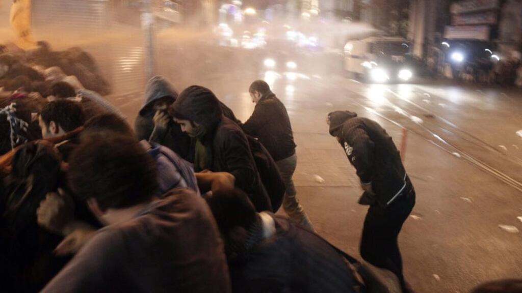Protesters run from a water cannon used by riot police to disperse them in Istanbul, during a pro-Kurdish demonstration in solidarity with the people of the Syrian Kurdish town of Kobani. Photograph: Osman Orsal /Reuters