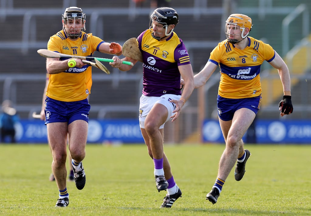 Wexford's Jack O'Connor tackled by Cathal Malone and David Fitzgerald of Clare during the league clash at Chadwicks Wexford Park. Photograph: Lorraine O'Sullivan/Inpho
Mandatory Credit ©INPHO/Lorraine O’Sullivan