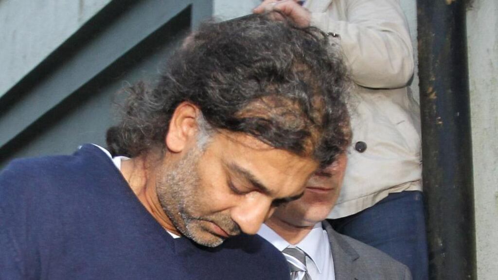 File photo  of Sanjeev Chada flanked by detectives arriving at Swinford District Court, Co Mayo last night, where he was charged with the murders of his two sons. Photograph: PA Wire