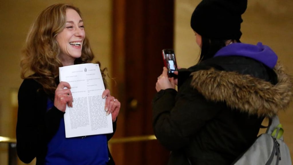 Valerie Scott (left), one of three current and former sex workers who initiated a challenge to Canada’s prostitution laws, has her picture taken with a copy of the ruling at the Supreme Court of Canada in Ottawa today. Photograph: Chris Wattie/Reuters