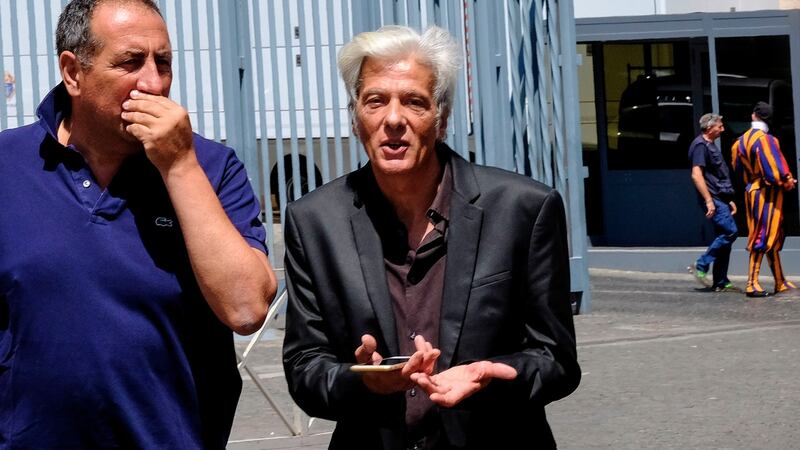 Emanuela Orlandi’s brother Pietro (centre), leaves the Vatican on Thursday after attending the opening of two tombs within the Vatican’s grounds in the Teutonic Cemetery. Photograph: Andreas Solaro/AFP/Getty Images