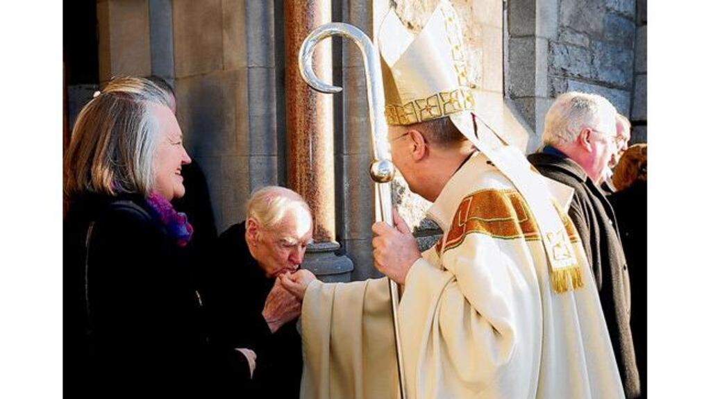 Former taoiseach Liam Cosgrave kisses Archbishop of Dublin Diarmuid Martin's ring after the Mass for world day of peace in Donnybrook church, Dublin, yesterday.