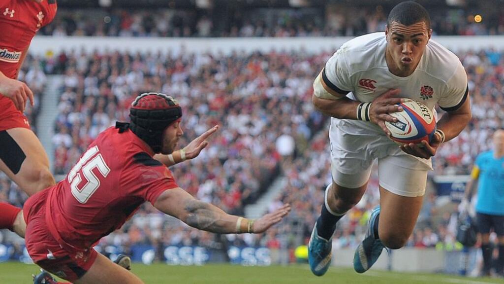 England’s Luther Burrell avoids the tackle of Wales’ Leigh Halfpenny to score his side’s second try during the Six Nations game at Twickenham. Photograph: Tim Ireland/PA