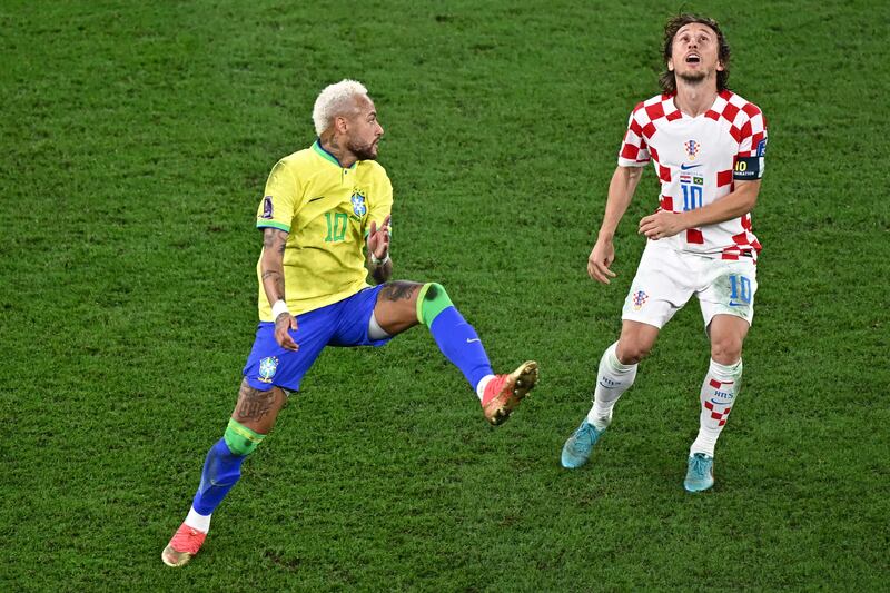 Neymar and Luka Modric eye the ball during the World Cup quarter-final at Education City Stadium. Photograph: Anne-Christine Poujoulat/AFP via Getty Images