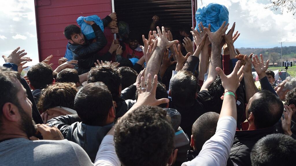 Migrants look to grab supplies donated by Greek people on March 11th, 2016, in a makeshift camp at the Greek-Macedonian border, near the Greek village of Idomeni. Photograph: Daniel Mihailescu/AFP/Getty Images