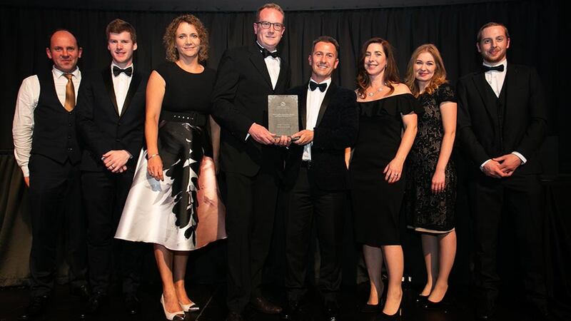 Stephen Pierce, National Sales Manager, Ireland, Vescom Wallcoverings & Fabrics presents the Conservation Award for a Single Building or Development award to the Niall Smith Architects Team.