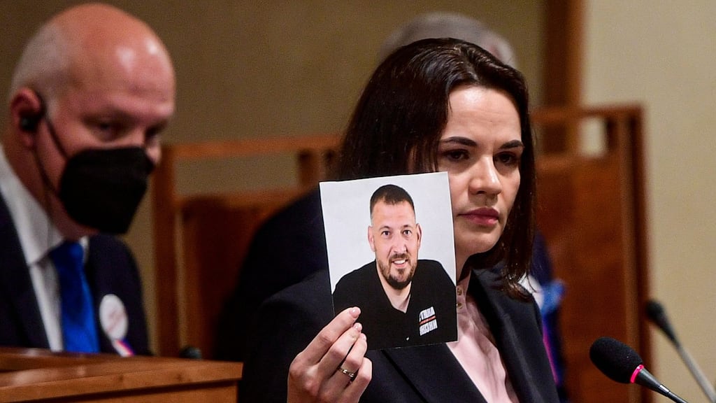 Belarusian opposition leader Svetlana Tikhanovskaya holds a picture of her husband, jailed blogger Sergei Tikhanovsky, during her speech in Prague in June. Photograph: Roman Vondrous/Pool/AFP via Getty Images