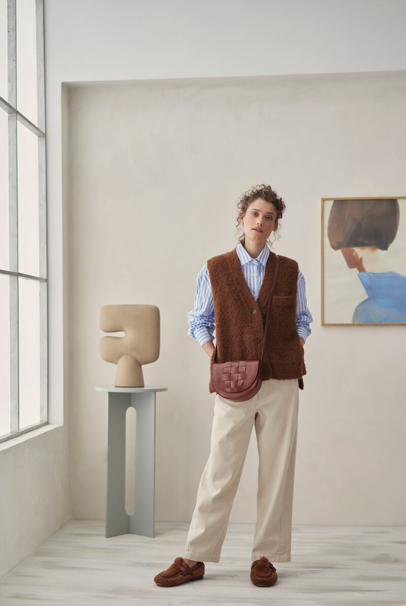 Toffee boucle waistcoat €235, striped cotton boyfriend shirt €235, wide soft pants €240, camel leather envelope bag €240, sanded ochre vase €169 by 101 Copenhagen, Blue Cape print €110 by Paper Collective. Photograph: Dylan Madden