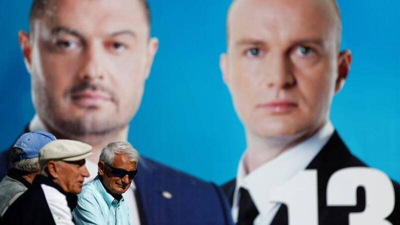 Men chat in front of an election poster of Bulgaria’s newly formed populist party ‘Bulgaria Without Censorship’ in Plovdiv on Wednesday. Bulgarian voters go to the polls Sunday to elect a new parliament after a turbulent period which has seen three governments go by the wayside since early 2013. Photograph: Stoyan Nenov/Reuters