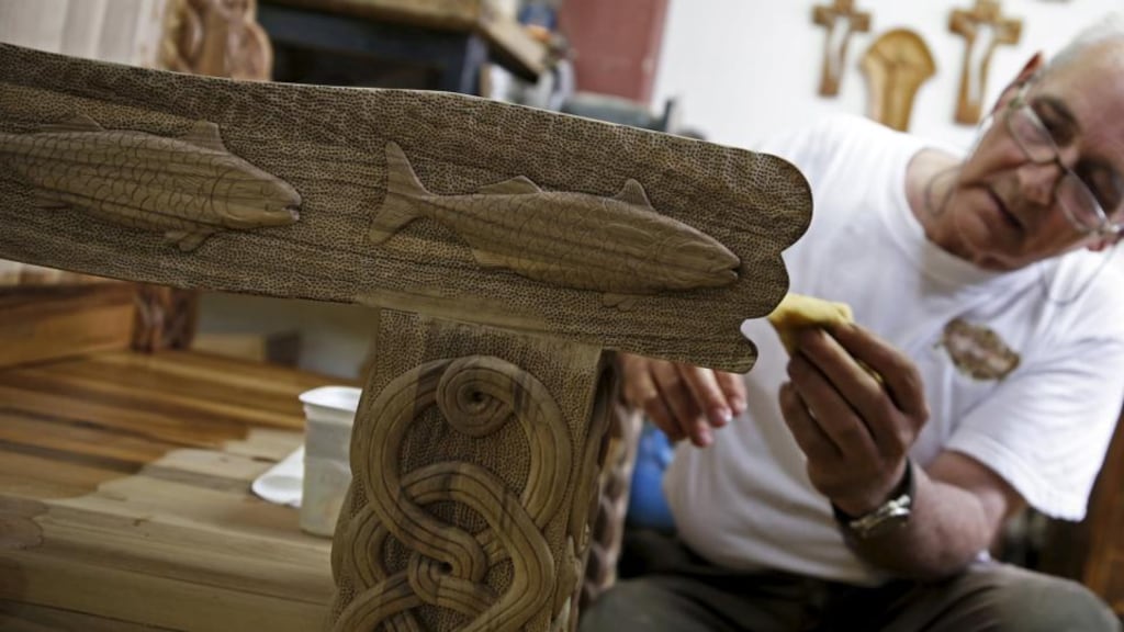 Bosnian wood carver-sculptor Salem Hajderovac works on a chair for  Pope Francis, at his workshop in Zavidovici, Bosnia. The chair, made from walnut trees, is to be used by the pope  during his visit to Sarajevo. Photograph: Dado Ruvic/Reuters