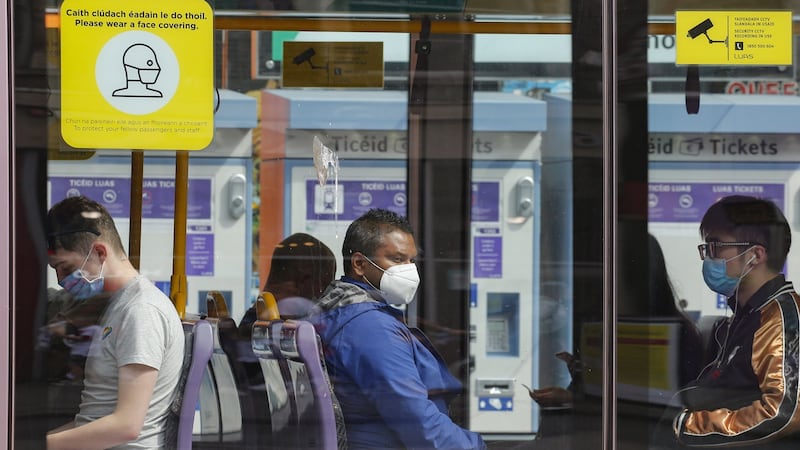 Luas passengers wearing masks: With entire teams off sick, there is massive disruption of normal work and elective hospital procedures are being cancelled once again. Photograph: Crispin Rodwell