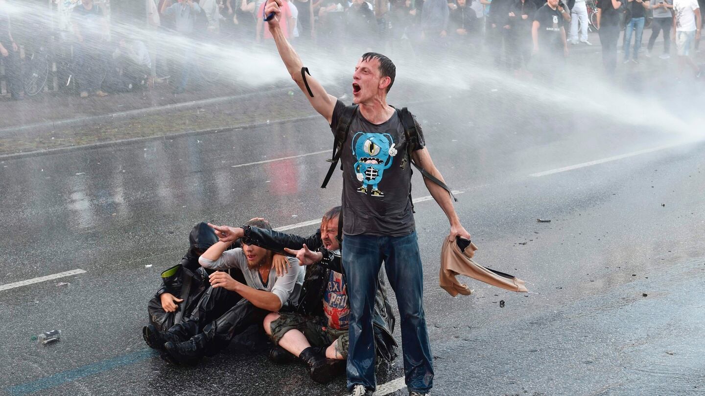 A protester shouts as riot police use water cannons trucks during a rally against the G20 summit in Hamburg, northern Germany. Photograph: Christof Stache/AFP/Getty Images