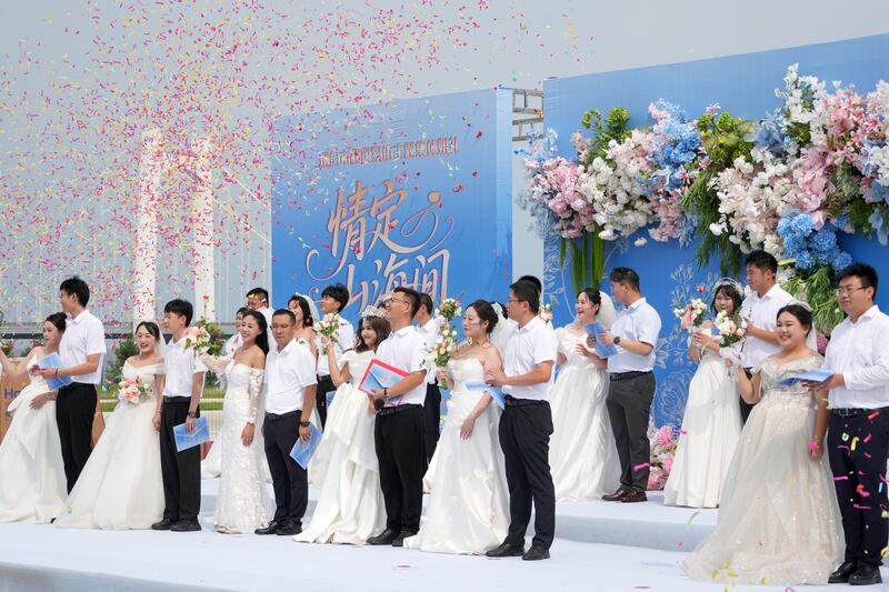 Newlyweds attend a collective wedding in Yantai, Shandong Province, China in August. Photograph: Tang Ke/ Future Publishing via Getty Images