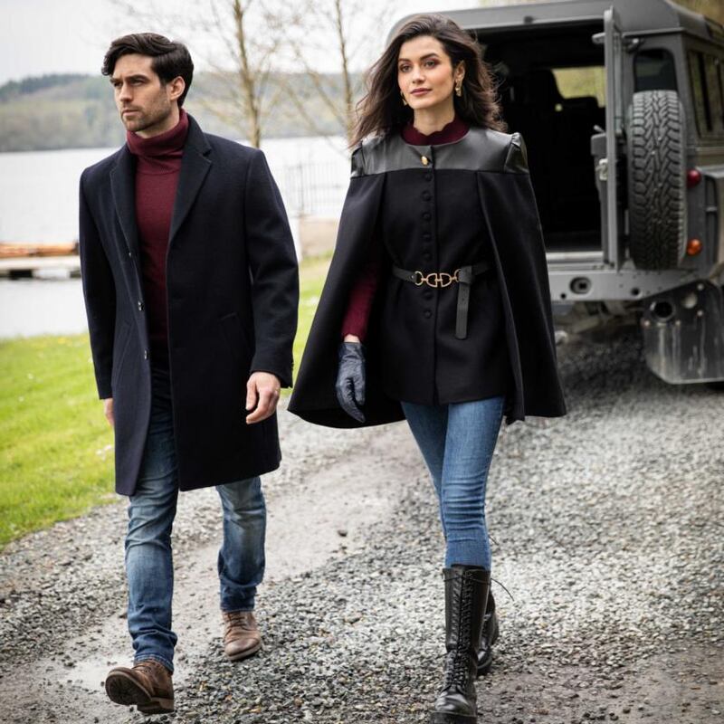 Left: Navy melton wool mid length coat (€315). Right: Tailored cape jacket (€320), burgundy cable knit (€80)
