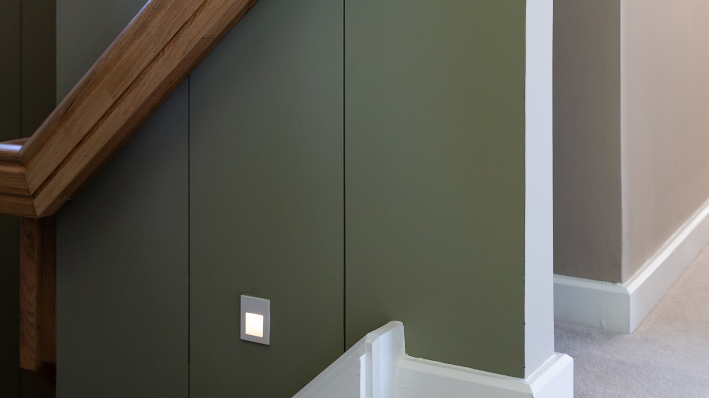 The oak handrail on the stairs.