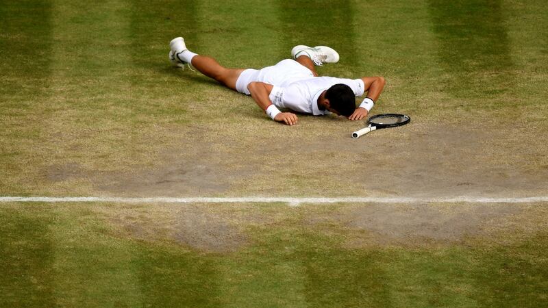 Djokovic falls to the ground after winning. Photo: Shaun Botterill/Getty Images