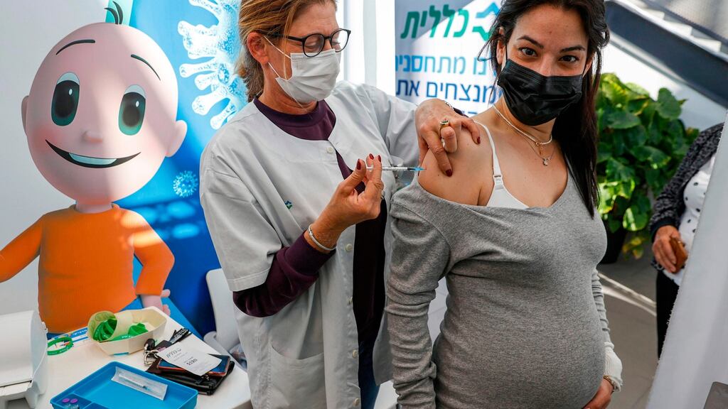 A health worker administers a dose of the Pfizer/BioNTech coronavirus vaccine to a pregnant woman at Clalit Health Services, in Tel Aviv, Israel in January. Photograph: Jack Guez/AFP via Getty Images