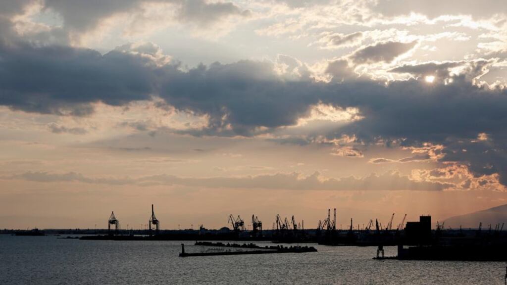 Cranes are silhouetted during sunset at the port of Thessaloniki, Greece. Bailout plan submitted by Greece to its creditors suggests the government will look at selling off state ports including Pireaus and Thessaloniki.