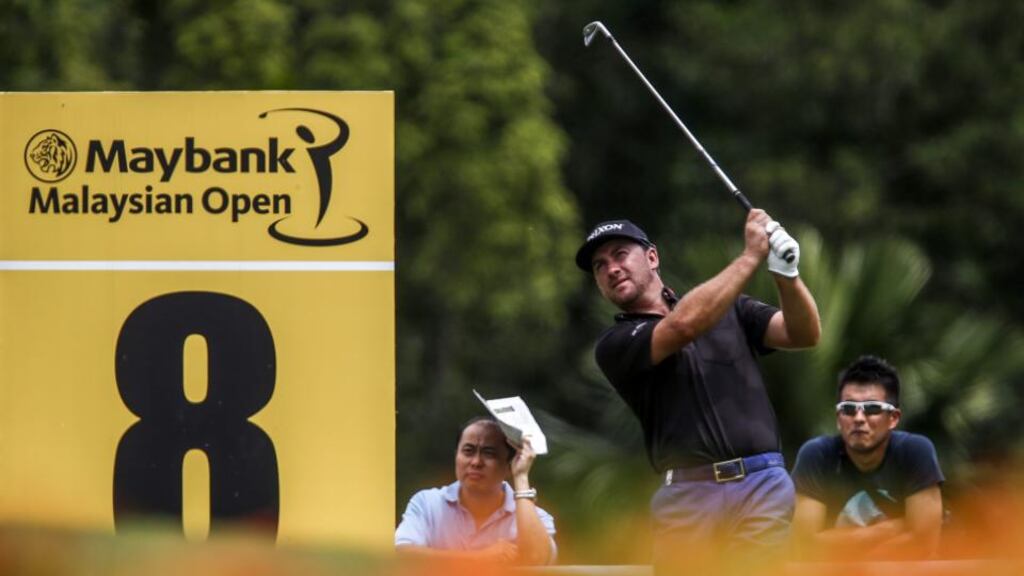 Graeme McDowell shares the lead with Lee Westwood after both shot a first round 66 at the Malaysian Open. Photograph: Azhar Rahim/EPA