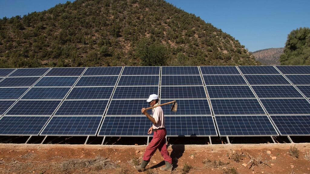 A  farmer walks past solar panels  in Tafoughalt, Morocco: the country is hosting  the first international climate summit since the Paris accord.  Photograph: Fadel Senna/AFP/Getty Images