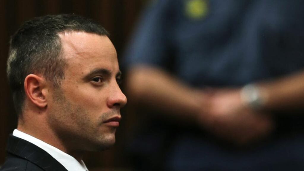 Paralympian Oscar Pistorius watches forensic expert Tom ‘Wollie’ Wolmarans giving evidence during his testimony at his murder trial at the high court in Pretoria today. Photograph: Themba Hadebe/EPA