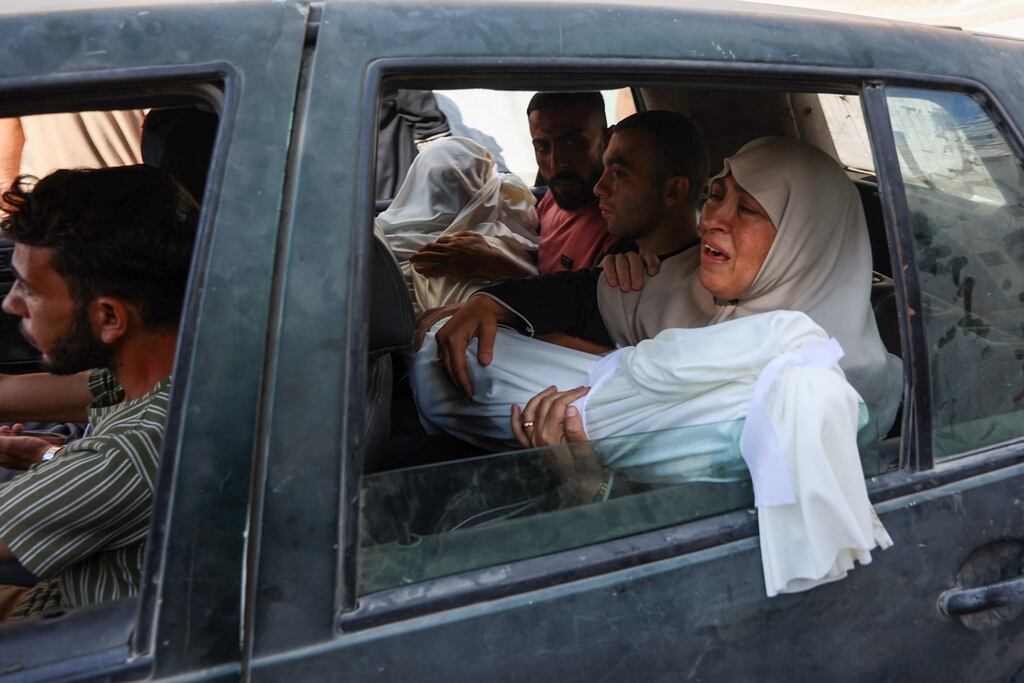 A Palestinian woman mourns as she holds the shrouded body of a relative, killed in an Israeli strike, before a funeral procession on July 9th, 2025. Photograph: Omar Al-Qattaa/AFP/Getty