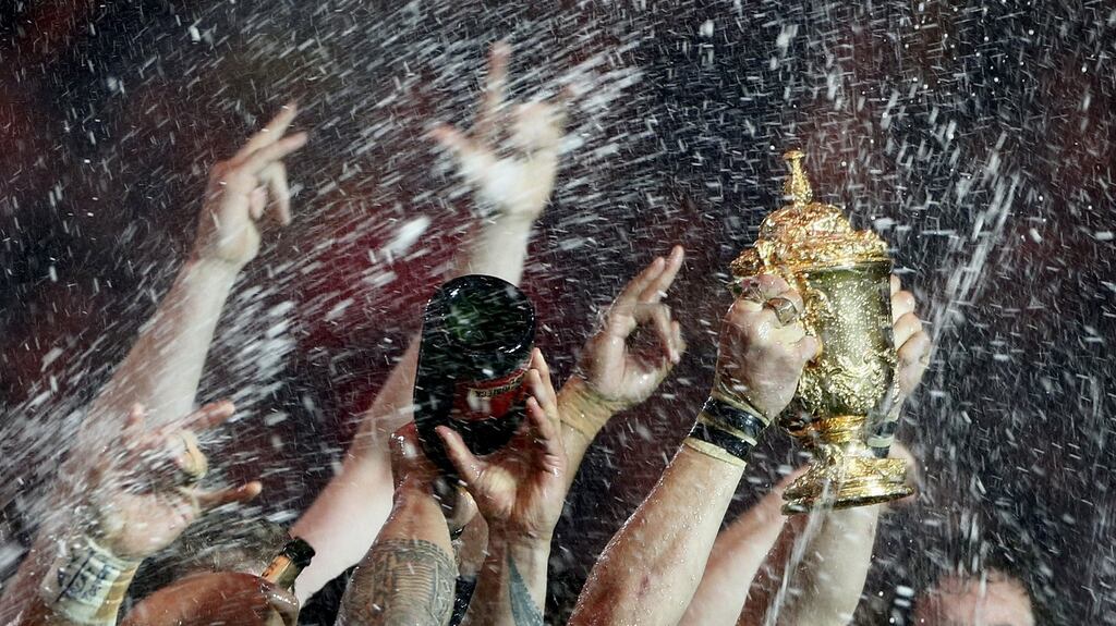 New Zealand’s team celebrates with the Webb Ellis trophy after winning the Rugby World Cup Final against Australia at Twickenham. Photograph: Stefan Wermuth/Reuters