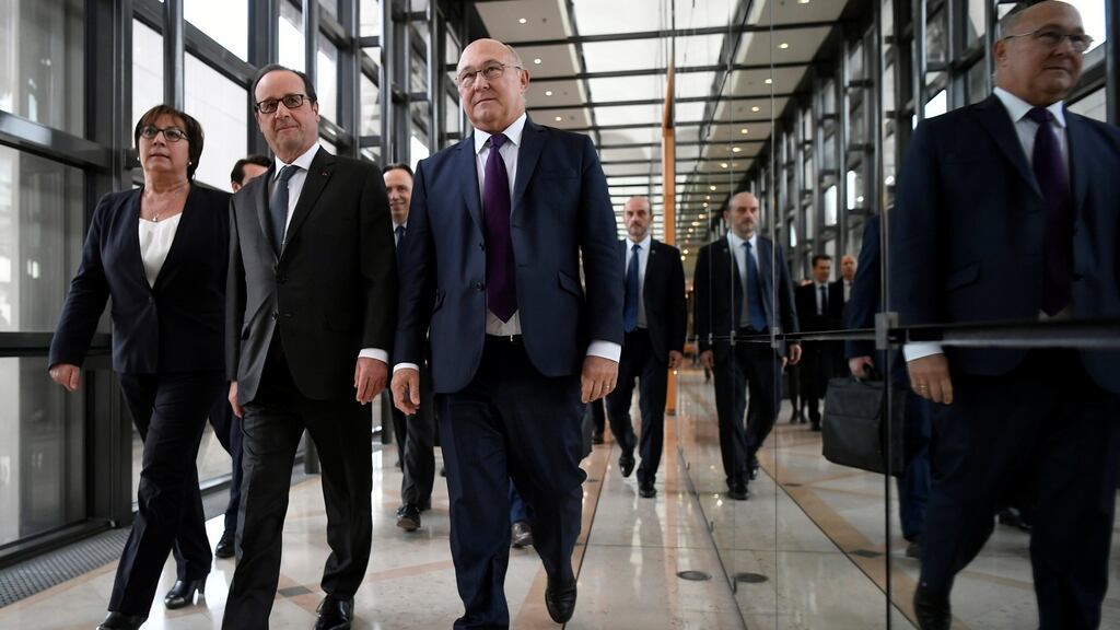 French minister for Economy and Finance Michel Sapin (right) with president Francois Hollande ((centre) and  French junior minister for Trade, Handicraft and Social and Solidarity Economy Martine Pinville (left) . Photograph: Lionel Bonaventure/Pool/Reuters