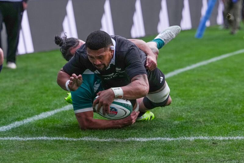 Ardie Savea holds off Ireland's James Lowe to score New Zealand's first try at Soldier Field last Saturday. Photograph: Robert Alam/Inpho/Photosport