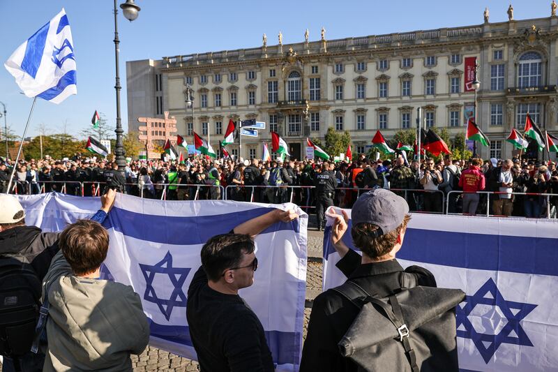Pro-Israeli protesters wave flags as pro-Palestinian demonstrators march past in Berlin last month. Photograph: Omer Messinger/Getty Images