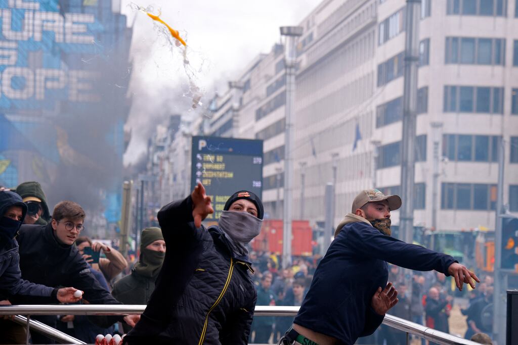 Protesters throw eggs at police forces as farmers demonstrate in Brussels. Photograph: Kenzo Tribouillard/AFP via Getty Images