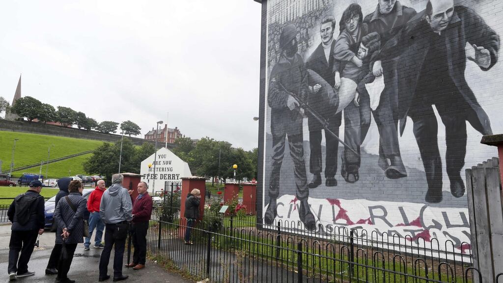 A mural depicts the late Bishop Edward Daly (right) waving a white handkerchief in the Bogside area of Derry. Photograph: Paul Faith/AFP/Getty Images