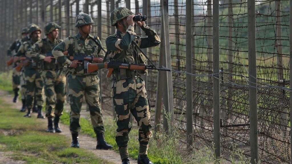 India’s Border Security Force (BSF) soldiers patrol along the fenced border with Pakistan in Ranbir Singh Pura sector. Photograph: Mukesh Gupta/Reuters