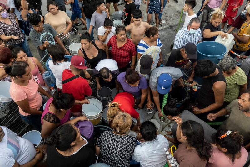 Residents of the Industrial neighbourhood wait to fill their containers with water in Monterrey. Photograph: Cesar Rodriguez/New York Times