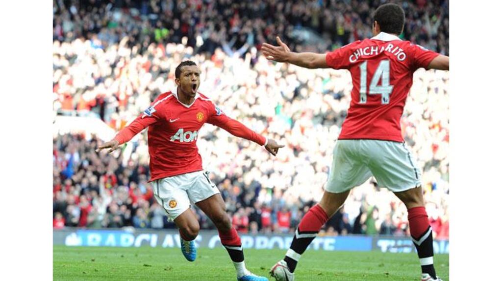 Manchester United's Luis Nani (left) celebrates after scoring Manchester United's second goal but Alex Ferguson's men let their lead slip again and registered their fifth draw of the season. - (Photograph: Martin Rickett/PA Wire)